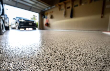 A low, angled view of an epoxy floor finish in a garage.