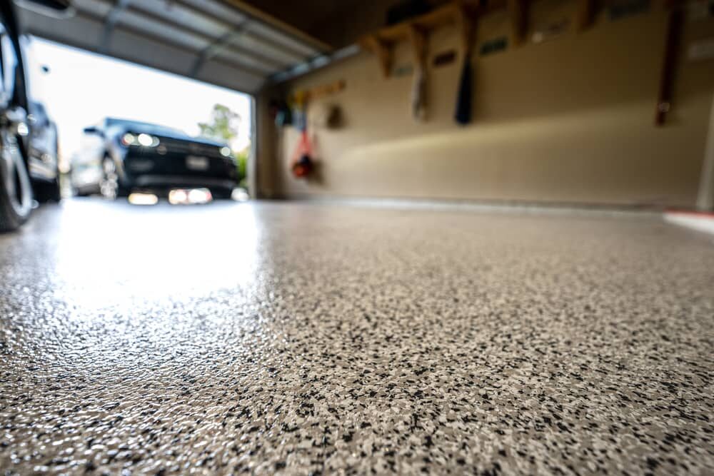 A low, angled view of an epoxy floor finish in a garage.