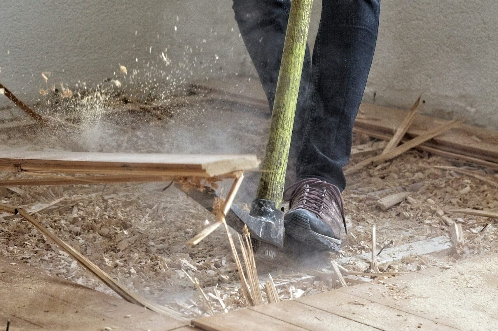 A demolition contractor tearing up a floor.